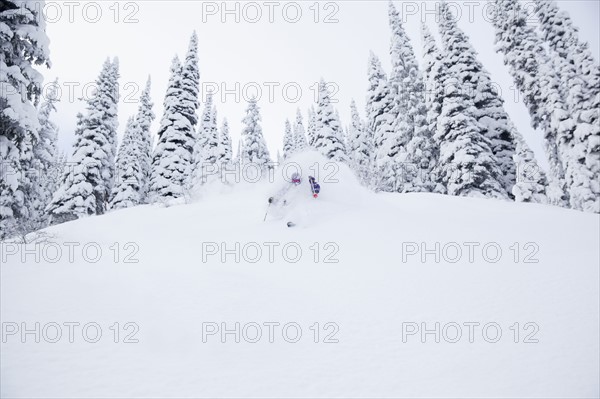 Young man skiing in forest