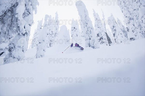 Young man skiing in forest