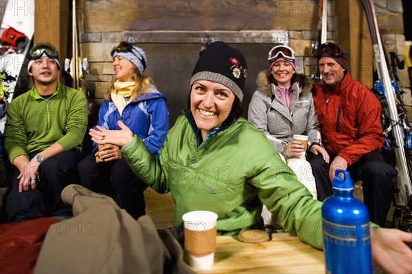 Group of skiers hanging out at fireplace