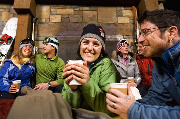 Group of skiers hanging out at fireplace