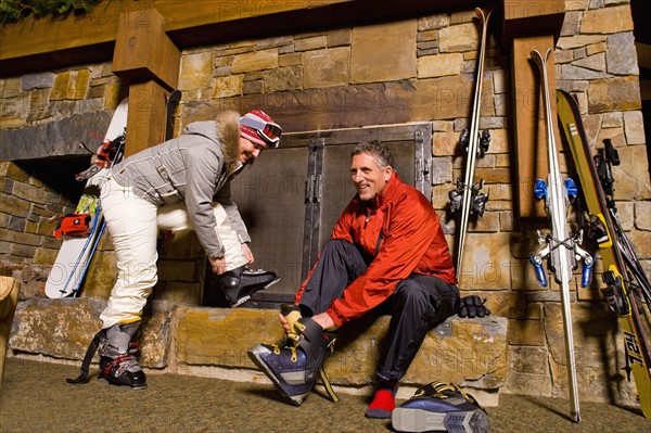 Skier putting on ski boots