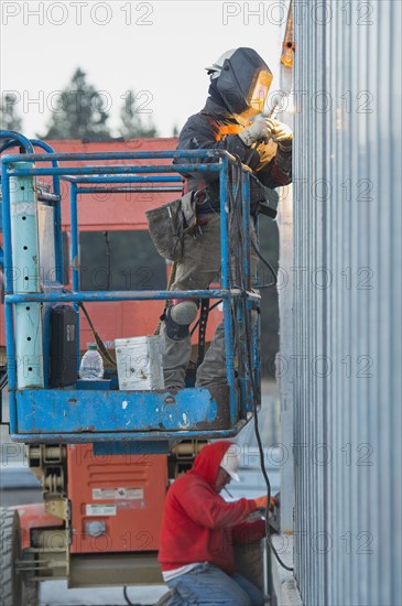 Men welding steel bar