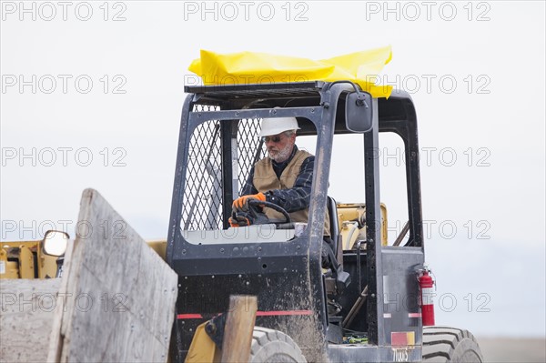 Senior man working on earthmover