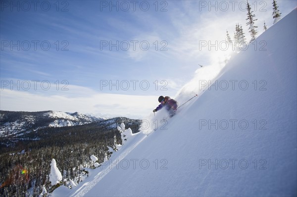 View of young man skiing in snowcapped mountains