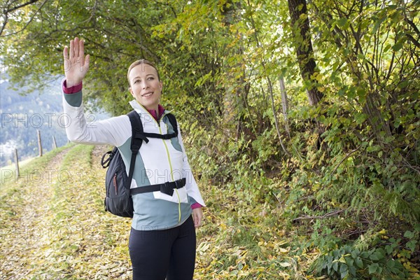 Woman waving at camera