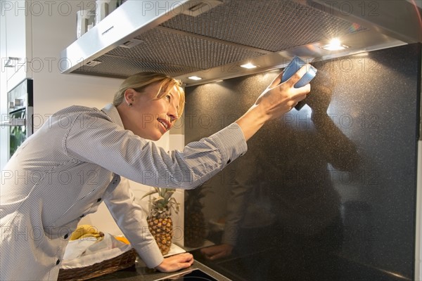 Woman cleaning kitchen