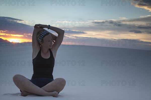 Mid-adult woman doing yoga in desert