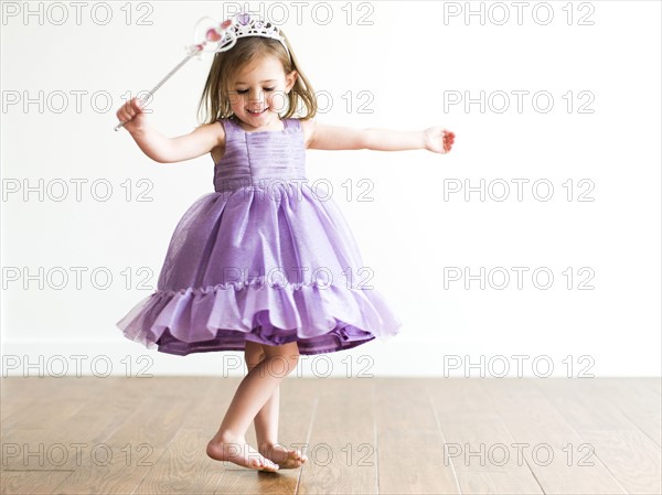 Girl (4-5) in princess costume dancing