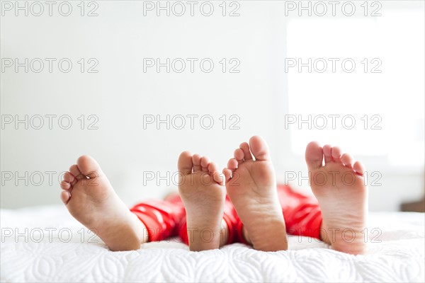 Siblings (2-3, 4-5) in red pajamas