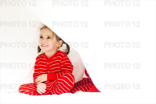 Girl (4-5) hiding in bed