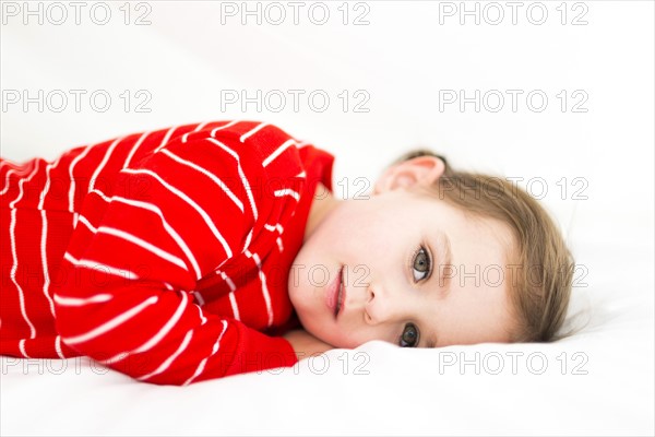 Girl (4-5) hiding in sheets