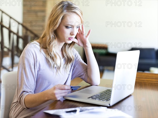 Young woman using laptop at table