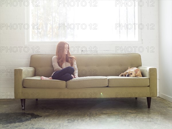 Woman and pug on sofa