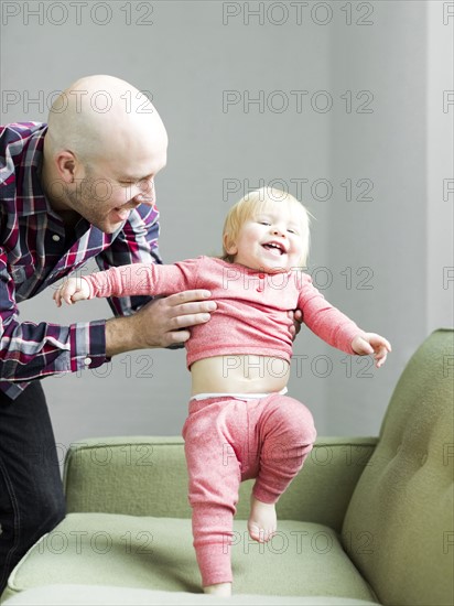 Father holding baby son (2-3)