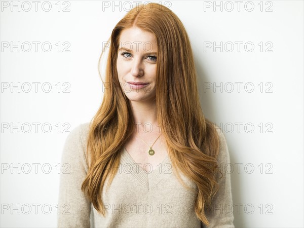 Portrait of woman with long red hair