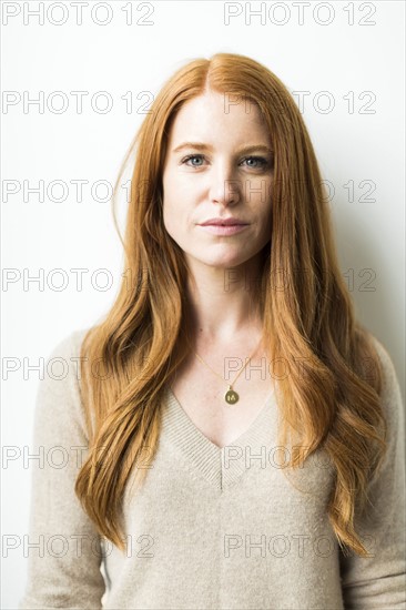 Portrait of woman with long red hair