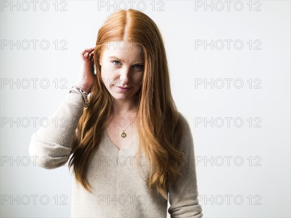 Portrait of woman with long red hair