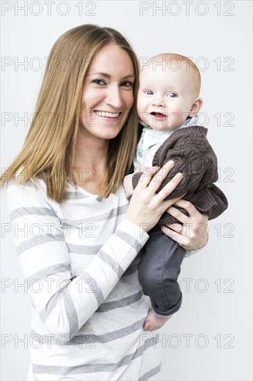 Mother holding baby son (6-11 months)