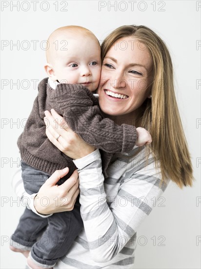 Mother holding baby son (6-11 months)