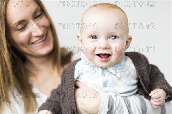 Mother holding baby son (6-11 months)