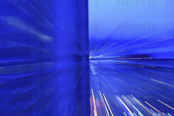 Motion blurred lights at dusk, abstract blue image