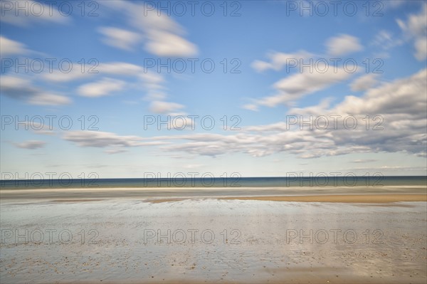 Sandy beach in water, horizon over sea