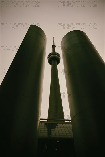 Low angle, symmetrical view of built structure and communications tower