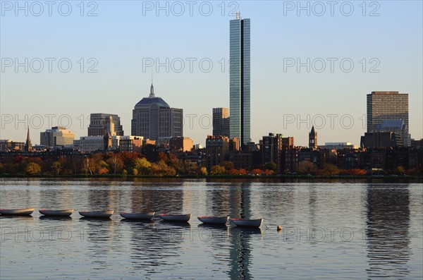 Row of boats on river, waterfront in background