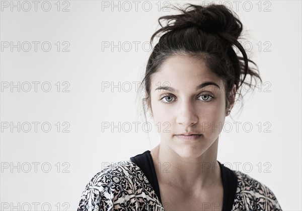 Portrait of teenage girl (14-15) in studio.