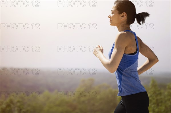 Young woman running outdoors.