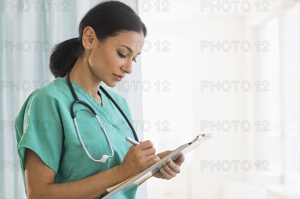 Female doctor making notes.