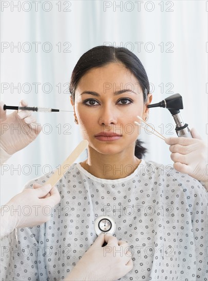 Patient being examined using medical instruments.