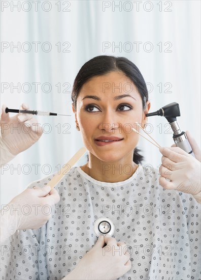 Patient being examined using medical instruments.