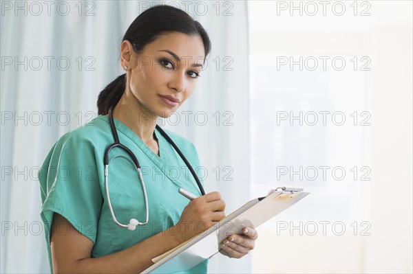 Female doctor making notes.