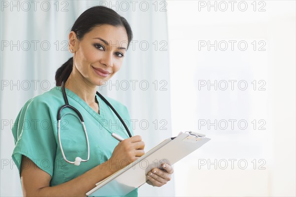 Female doctor making notes.