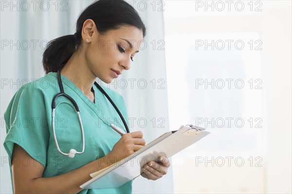 Female doctor making notes.