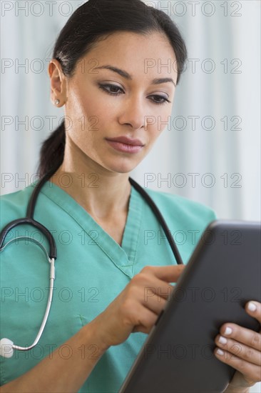 Female doctor using digital tablet.