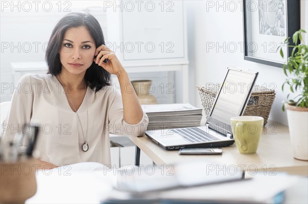 Woman sitting at desk with laptop.