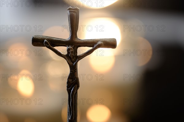 Cross with lens flares in background.