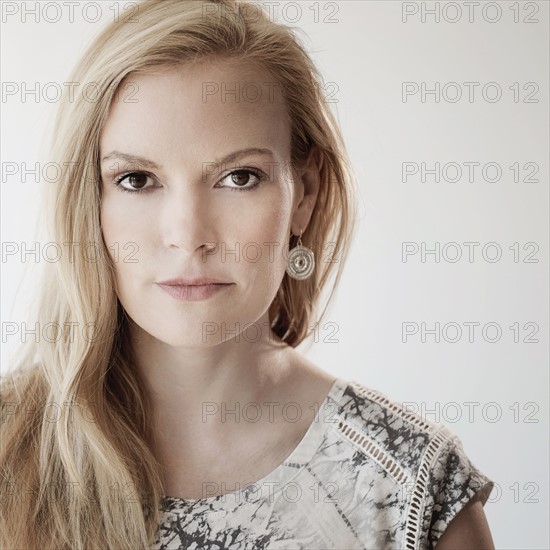 Portrait of mid-adult woman on white background.