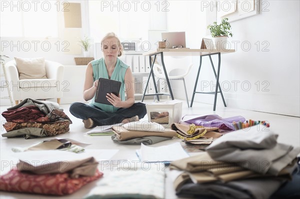 Design professional working in living room.