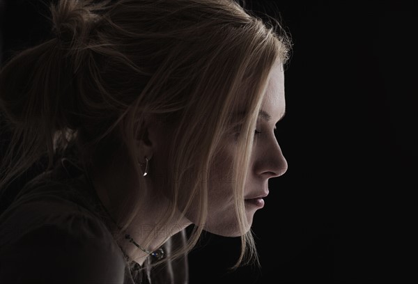 Portrait of blond woman in studio.