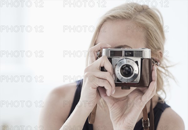 Woman taking photo with digital camera.