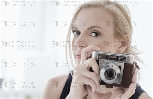 Woman holding digital camera.