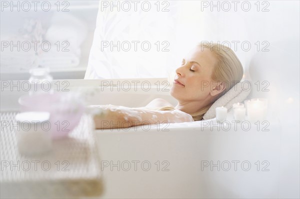 Woman relaxing in bath.