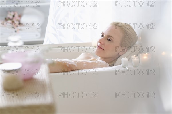 Woman relaxing in bath.