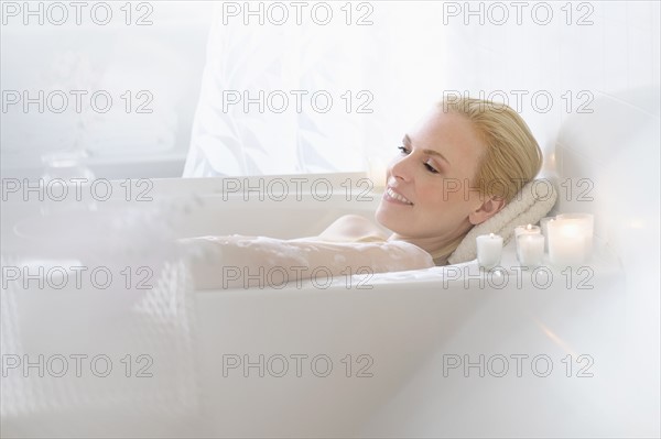 Woman relaxing in bath.