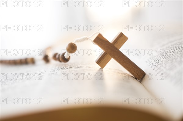 Rosary beads in open Bible.