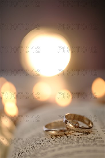 Wedding rings in open Bible.