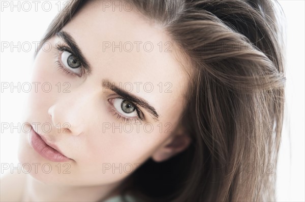 Portrait of young woman in studio.